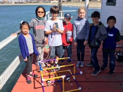 A group of kids on the pier with an ROV