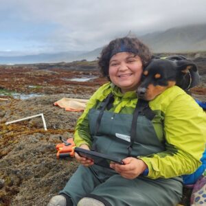 Jaclyn and her dog, Dori, pose during field work along the coast
