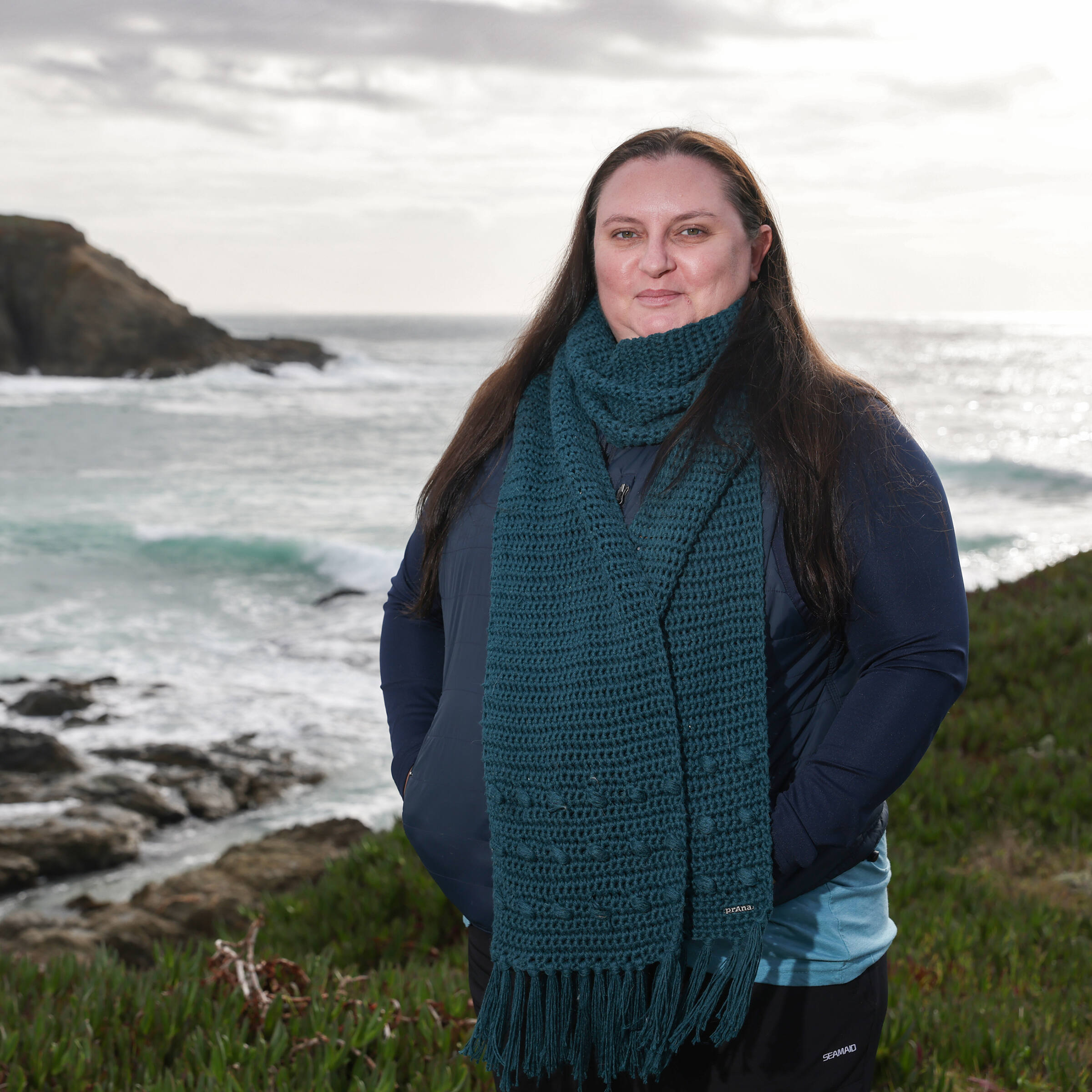 Rietta Hohman stands in front of a beach along the Sonoma Coast.